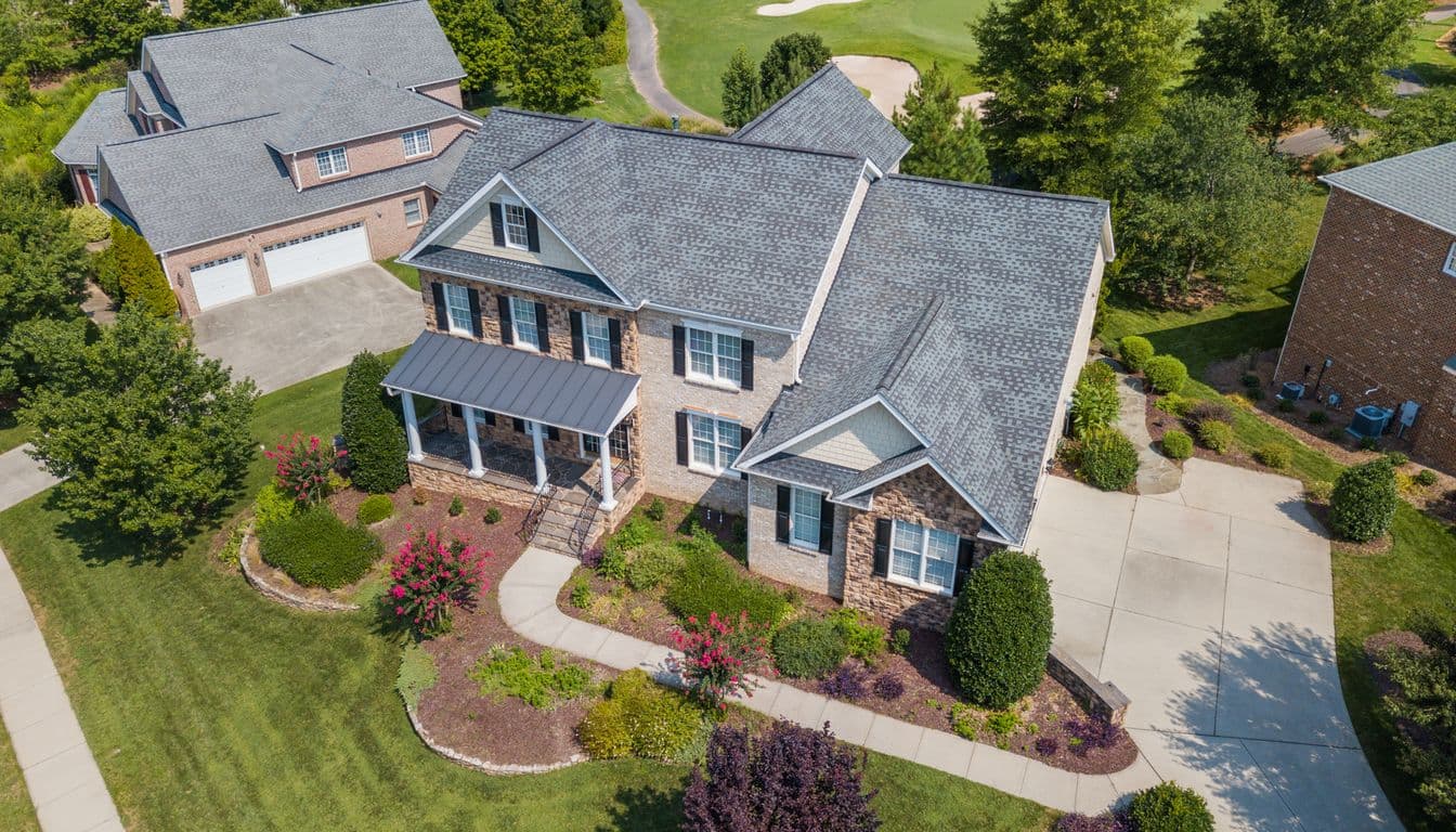 Aerial view of a single-family home with a freshly manicured lawn